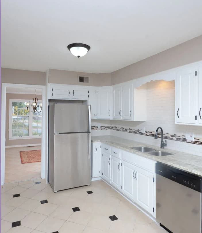 This is an image from Home Pros Painting And Home Repairs. The image is an updated kansas kitchen with white cabinets, stainless appliances, and freshly painted walls.