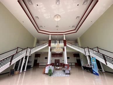 Interior painting project by GW Painting in Charlotte, NC. The image shows a large open room with white railings, high walls, and ceiling lights.
