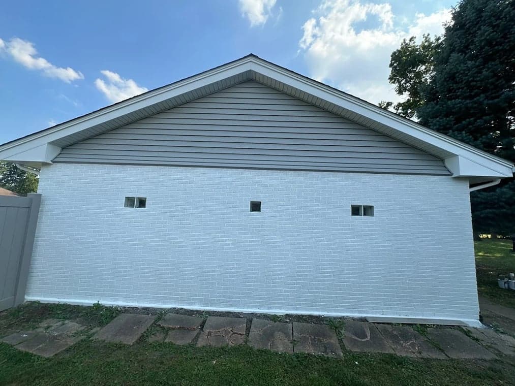 Exterior painting by Slaviks Painting & Decorating in Wood Dale, IL. The image shows a white-painted brick garage wall.
