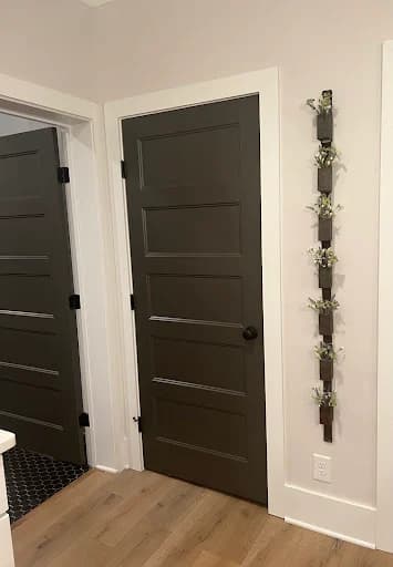 Room Ninjas painting project in Columbia, Tennessee. The image shows dark gray interior doors framed by crisp white trim.