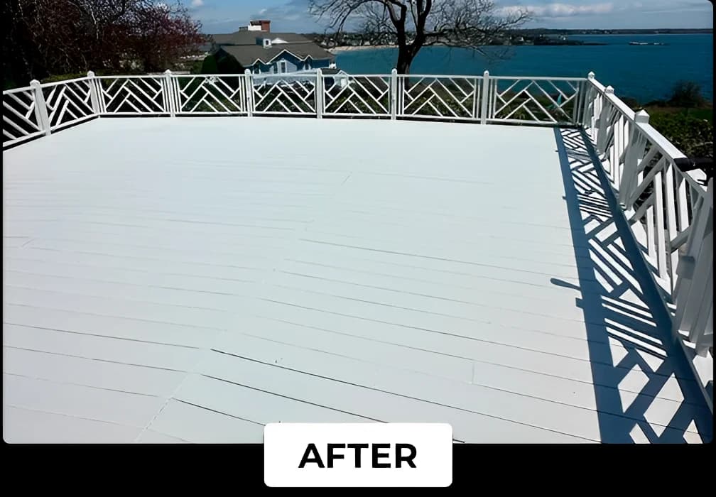 A large outdoor deck painted bright white by Lucena Painting, overlooking a scenic waterfront view with houses and trees in the distance.