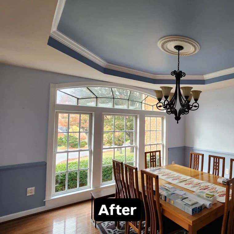 This is an image from FR Contractors & Investors Inc, located in Virginia. The photo shows a freshly painted dining room with a blue coffered ceiling, white trim, large windows, and a wooden dining table set beneath a decorative chandelier.