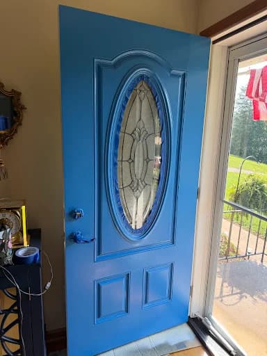 Painting work by Mike’s Painting in Oak Ridge, Tennessee. The image shows a blue front door framed by white trim.