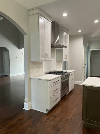 Interior painting project by Avanti Painting LLC in Mooresville, NC. The image shows a kitchen wall with light cabinets and wood floors.