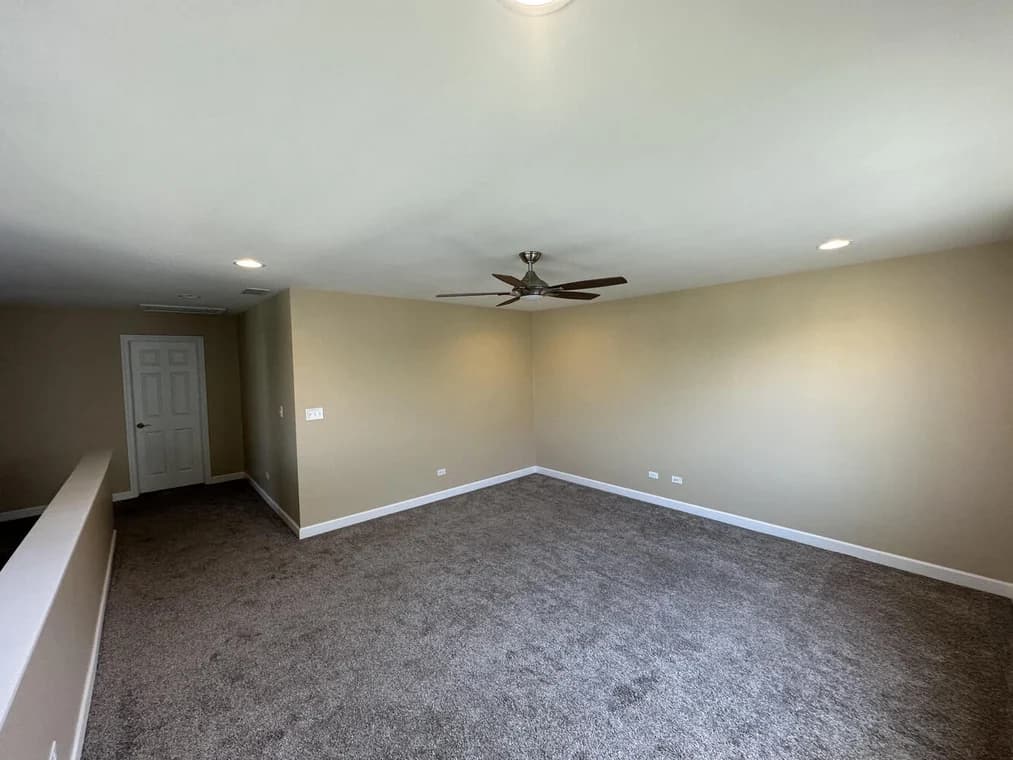 Interior painting by Slaviks Painting & Decorating in Wood Dale, IL. The image shows a beige room with white trim and carpet.