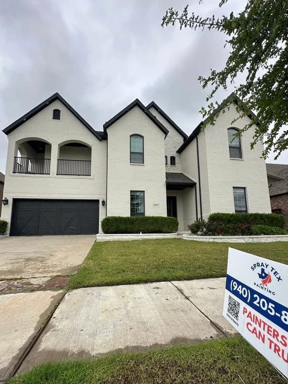 This is an image from Spray Tex Painting, located in Texas. The exterior photo shows a light-colored painted brick home with dark trim, a three-car garage, and a Spray Tex Painting yard sign in the foreground.