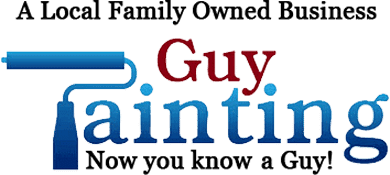 This is an image from Guy Painting, located in Indiana. The image shows a freshly painted interior hallway with gray walls, white wainscoting, crisp trim work, wood-look flooring, and a modern light fixture, demonstrating professional interior painting services.