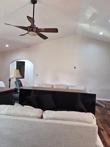 Painting work by Whaley's Painting and More in Dandridge, Tennessee. The image shows another view of the white living room and wood floor.