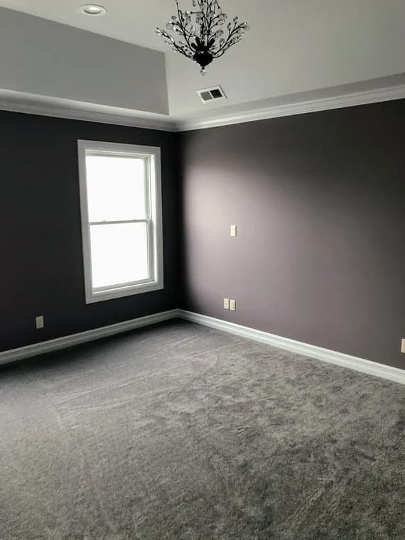 This is an image from Painting by Robertson, located in California. The image shows a freshly painted interior bedroom with smooth gray walls, white crown molding, and clean baseboard finishes.