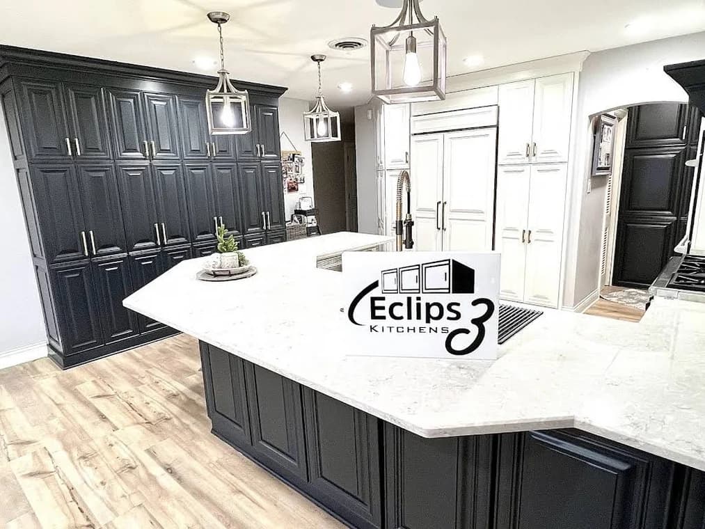 Kitchen cabinet refinishing by Eclips3 Kitchens LLC in Orland Park, IL. The image shows a two-tone kitchen with black and white cabinets.