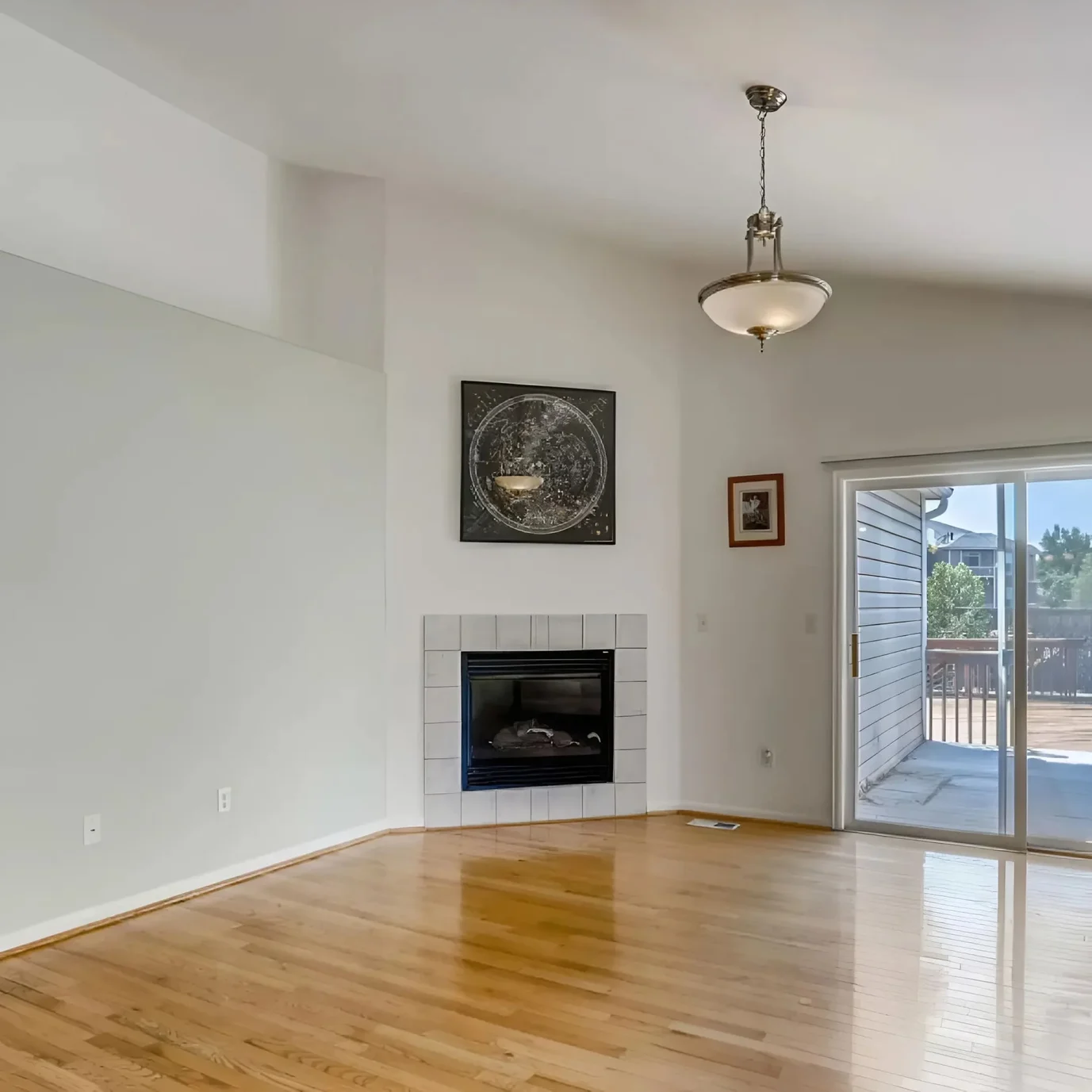This is an image from Neighborhood Painting and Restoration. The image is living room in Kansas City KS with light neutral walls and hardwood floors