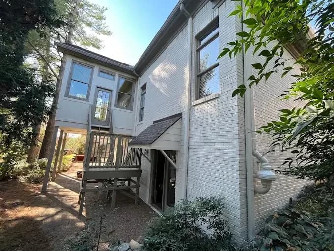 Painting work by Global Painting Pro LLC in Nashville, Tennessee. The image shows a rear house exterior painted bright white.