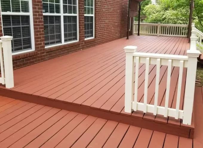 Painting work by Global Painting Pro LLC in Nashville, Tennessee. The image shows a red stained deck with white railings.