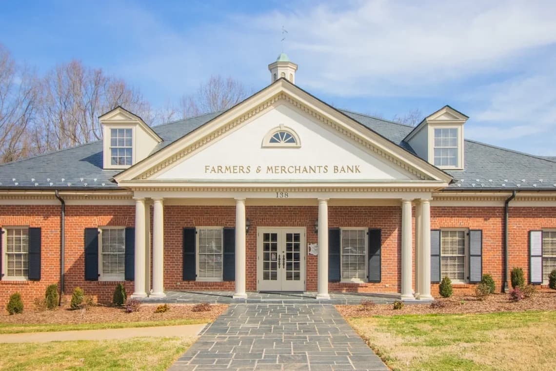Commercial exterior painting project by Richard's Painting of Lexington, NC in Salisbury, NC. The image shows a brick office building with white columns and trim.