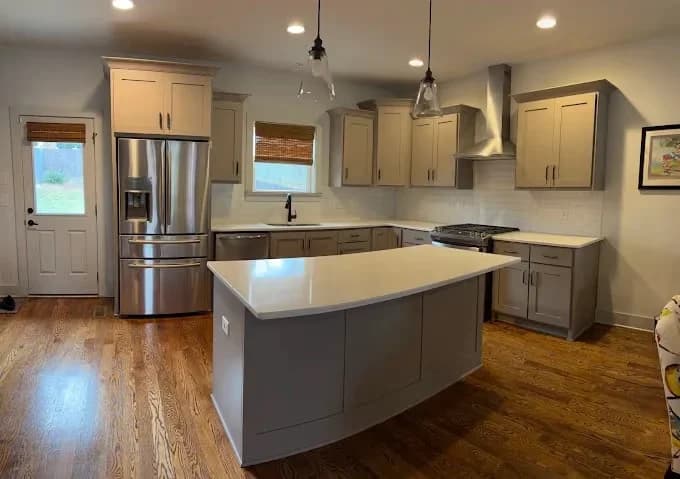 Pointer Painting painting project in Hermitage, Tennessee. The image shows a gray-and-white kitchen with a large island.