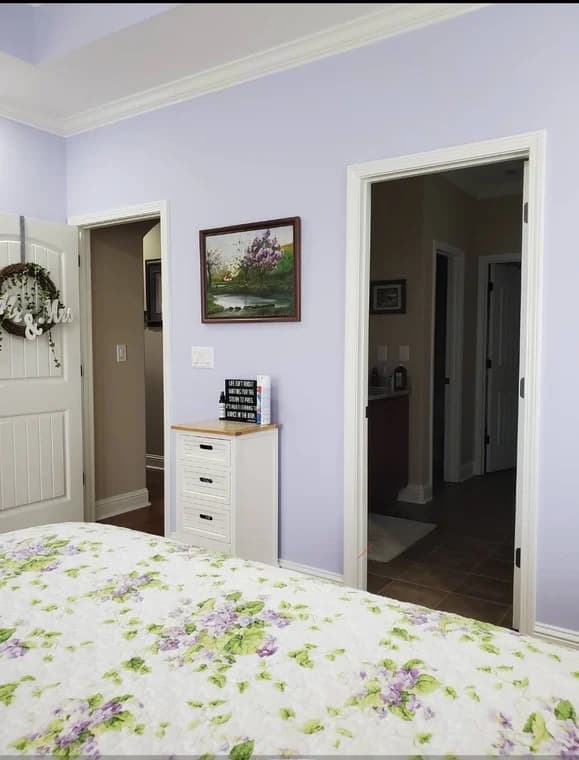Bedroom with pale lavender walls and white trim painted by CertaPro Painters of Clarksville, Tennessee and Hopkinsville, Kentucky.