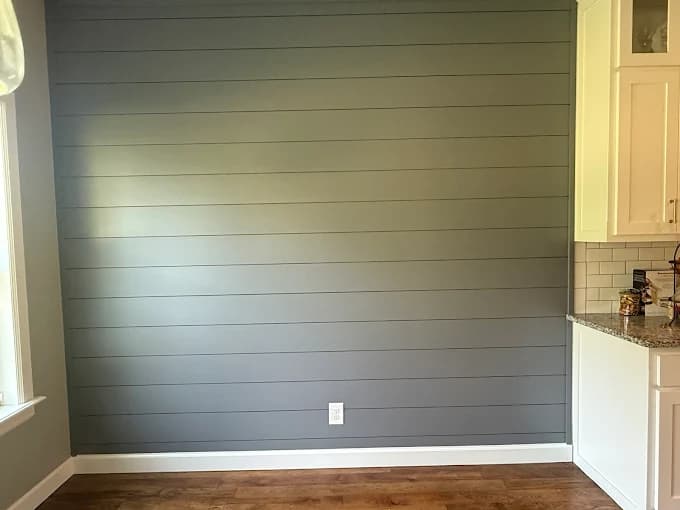 Interior wall with gray horizontal shiplap panels beside a kitchen counter, freshly painted by Groovy Hues Painting of Tulsa.