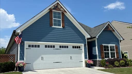 Ridgeline Pro Painters painting project in Chattanooga, Tennessee. The image shows a blue home exterior with a white garage door.
