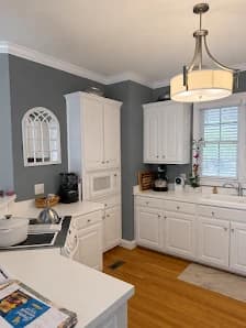 Interior painting project by CertaPro Painters of Greensboro, NC in Greensboro, NC. The image shows a kitchen with pendant lighting.