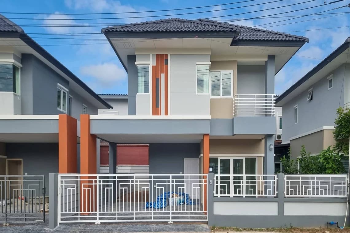 This is an image from Ponderosa Painting LLC, located in  Louisiana. The photo shows a freshly painted modern two-story home with gray, beige, and orange accents, highlighting clean exterior lines and professional paintwork.