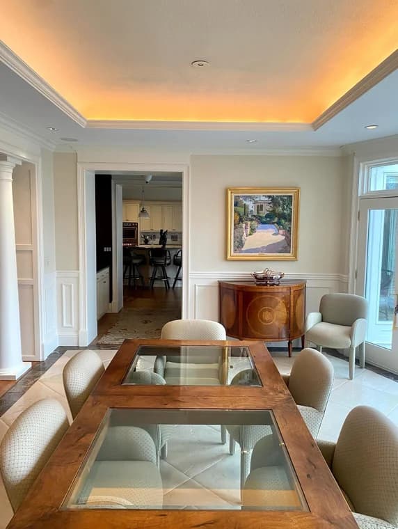 Interior painting project by Hansell Painting Co in Durham, NC. The image shows a dining room with cream walls, white trim, and a tray ceiling.