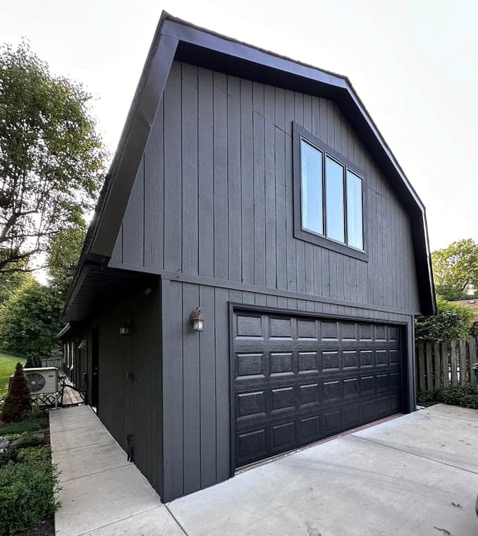 Exterior painting by Affordable Interior & Exterior Painting in Glen Ellyn, Illinois. The image shows a dark gray garage with black trim and a black door.