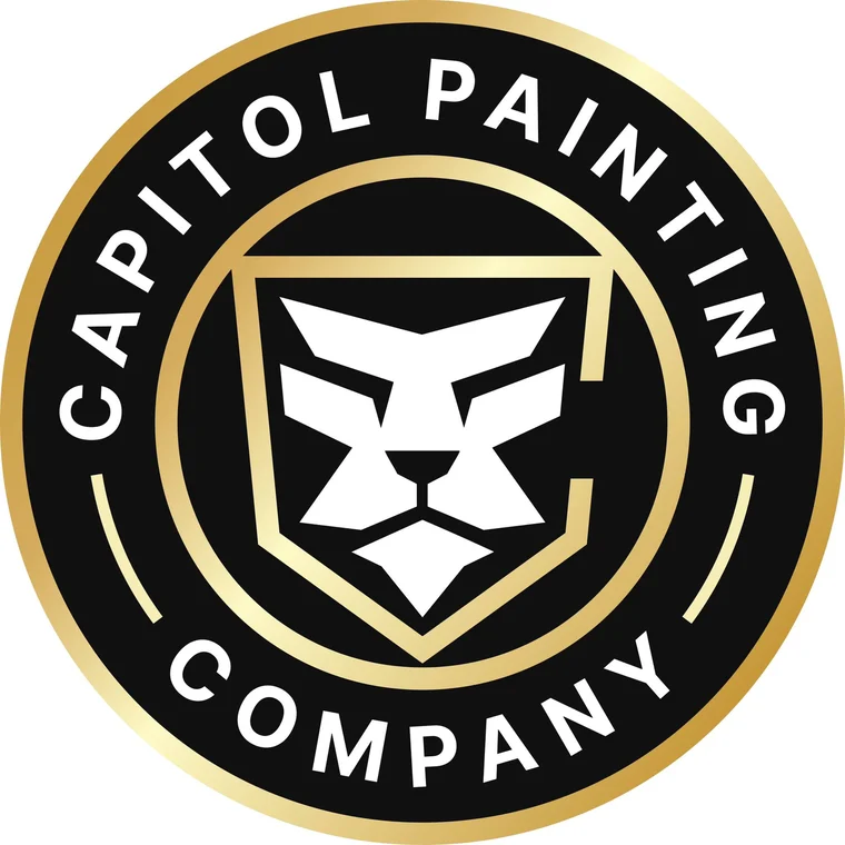 This is an image from Capitol Painting Company, located in Washington. The logo for Capitol Painting Company features a bold black and gold circular badge with a stylized white lion head emblem in the center, representing strength and quality craftsmanship.