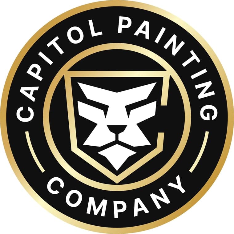 This is an image from Capitol Painting Company, located in Washington. The logo for Capitol Painting Company features a bold black and gold circular badge with a stylized white lion head emblem in the center, representing strength and quality craftsmanship.
