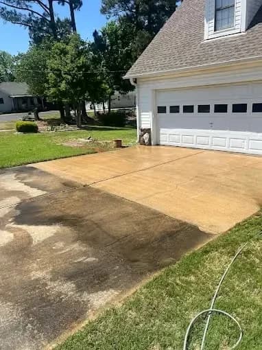 Painting project by Healthy Home Pros in Millington, Tennessee. The image shows a cleaned driveway beside a white garage.
