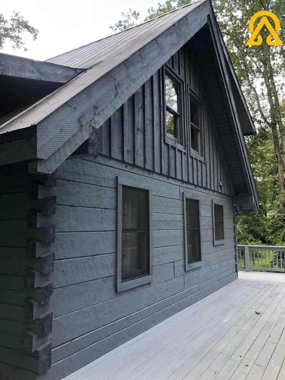 Exterior painting project by Alpha Omega Painters LLC in Burnsville, North Carolina. The image shows gray siding, white trim, and a steep gable roof.