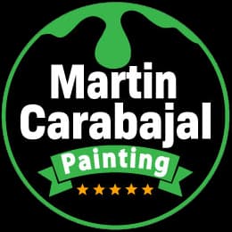 This is an image from Martin Carabajal Painting, located in California.The logo for Martin Carabajal Painting features bold white lettering on a black circular badge with green paint drip accents, a green ribbon banner, and five gold stars.