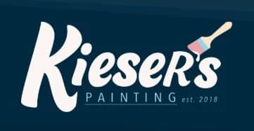 This is an image from Kieser's Painting, located in Nebraska. The logo for Kieser's Painting features white script lettering on a dark blue background with a small paintbrush accent.