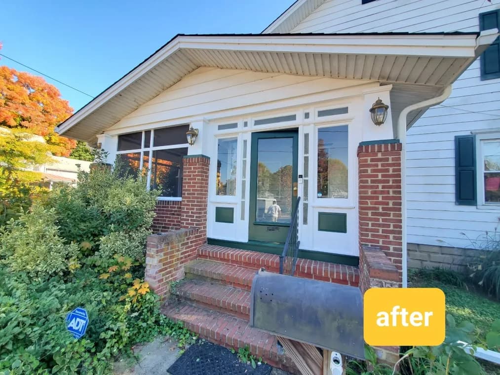 Exterior view of a home with white siding, red brick columns, and a front porch freshly painted, showcasing Four Golden Brothers Painting’s work.
