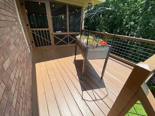 Painting work by Scott Brown Professional Painting & Remodeling in Chattanooga, Tennessee. The image shows a brown deck with cable railings.