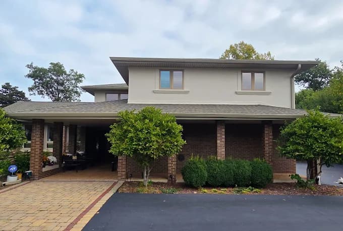 Rhino Shield of Chicagoland completed this Illinois exterior project. The image shows a beige home with brick columns and landscaped grounds.