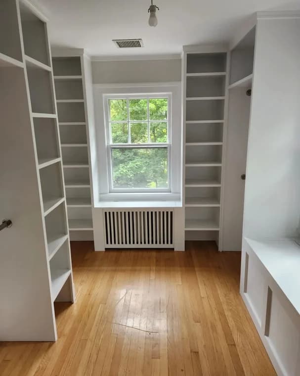 This is an image from Mark Tirondola Jr. Painting Contractor LLC in New Jersey. It shows an interior space with built-in shelving and crisp white trim against neutral walls.
