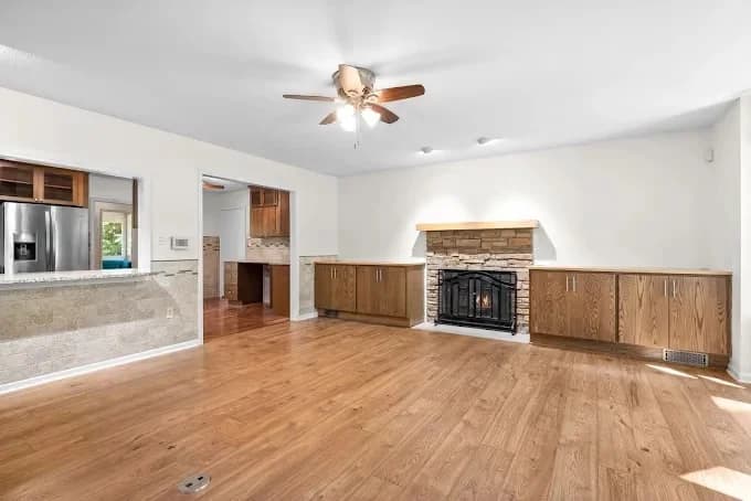 Painting project by Martin's Quality Painting in Clarksville, Tennessee. The image shows a bright white room with wood flooring.