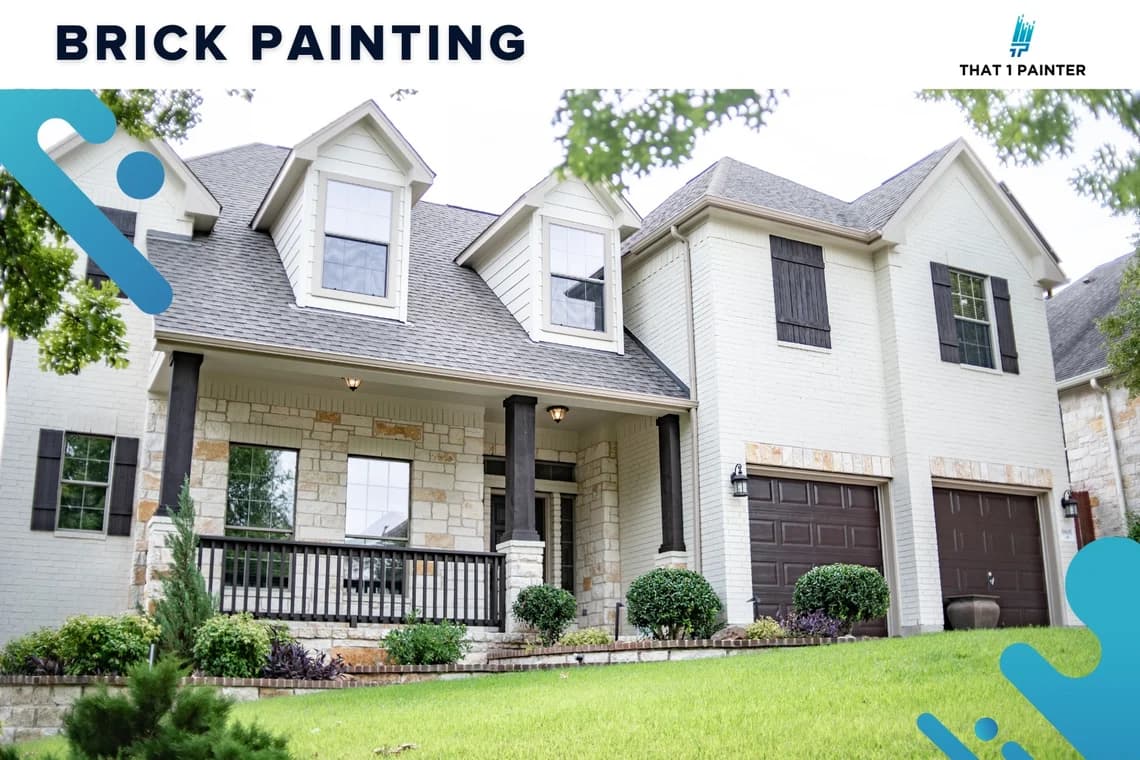 This is an image from That 1 Painter Greater Boston, located in Massachusetts. The photo shows a freshly painted light brick home with dark shutters and a landscaped yard, highlighting the company’s brick painting services.