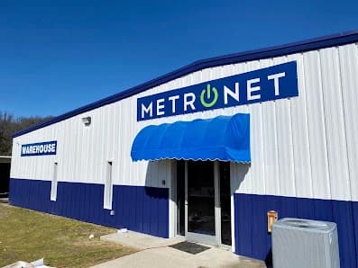 Commercial exterior painting by CertaPro Painters of Fayetteville, NC in Lillington, NC. The image shows a white and blue warehouse front.