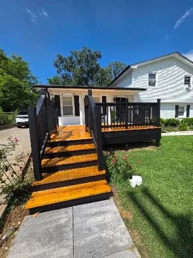 Pointer Painting painting project in Hermitage, Tennessee. The image shows newly stained wood deck steps with dark railings.
