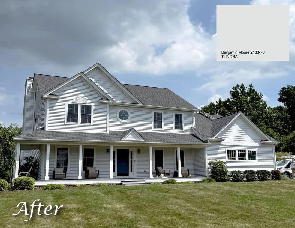 This is an image from CertaPro Painters of Orange County NY, located in New York. The photo shows a freshly painted two-story home with light gray siding, white trim, and a clean, updated exterior under a cloudy sky.