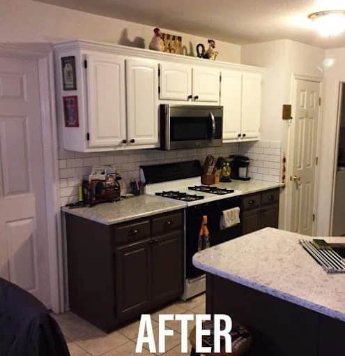 A modern kitchen with freshly painted white upper cabinets, dark brown lower cabinets, subway tile backsplash, and marble-style countertops, shown after renovation.