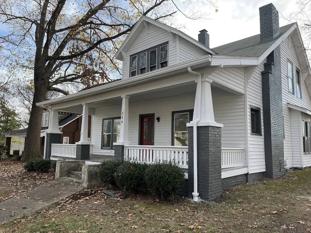 Two-story home with gray siding and white porch trim painted by CertaPro Painters of Clarksville, Tennessee and Hopkinsville, Kentucky.
