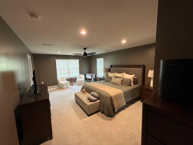 Interior painting by AllBright Pro Painting in Smyrna, Tennessee. The image shows a bedroom with dark walls, beige carpet, and recessed lights.