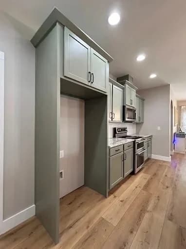 Painting work by Suzuki Painting in Whitesburg, Tennessee. The image shows a wall of gray cabinets with black hardware.