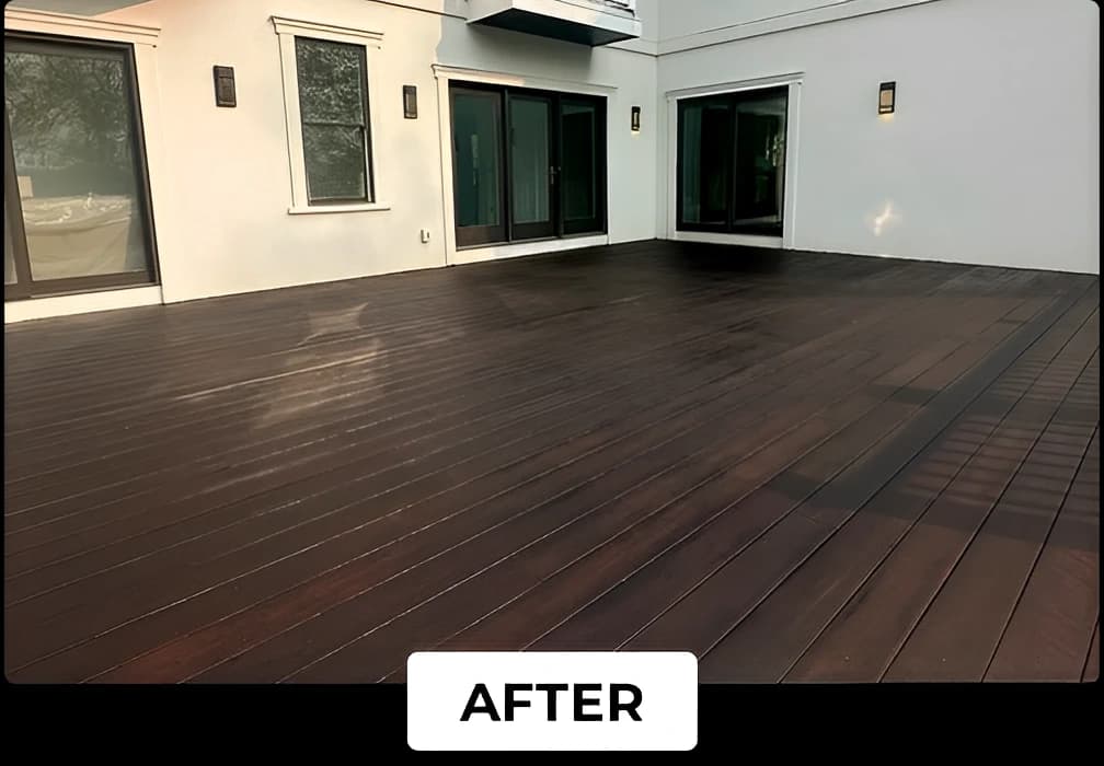 A modern wooden deck finished with a rich dark stain by Lucena Painting, complementing the clean white walls and glass doors of the home.