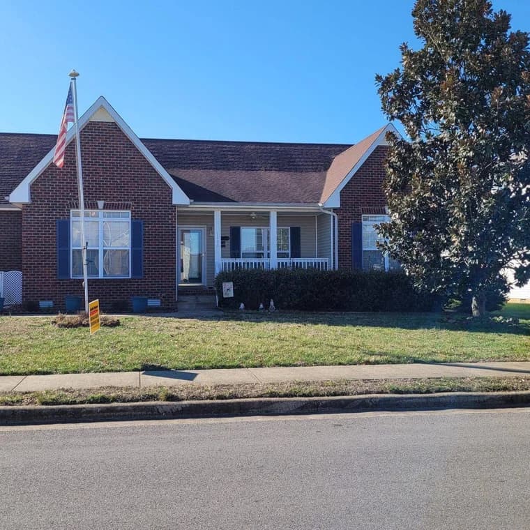 Brick home with white trim painted by CertaPro Painters of Clarksville, Tennessee and Hopkinsville, Kentucky.