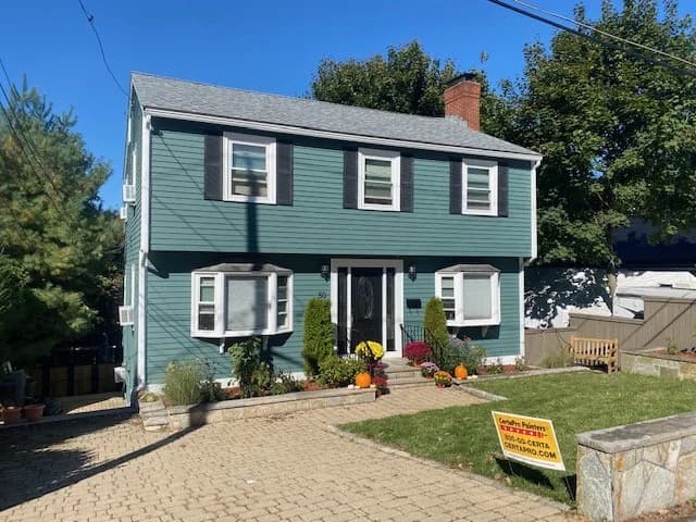 This is an image from CertaPro This is an image from CertaPro Painters of North Shore and Cape Ann, located in Massachusetts. The photo shows a green two-story colonial-style home with black shutters, a brick chimney, and a sign in the yard indicating professional painting services.of North Shore and Cape Ann, located in Massachusetts. The photo shows a green two-story colonial-style home with black shutters, a brick chimney, and a sign in the yard indicating professional painting services.
