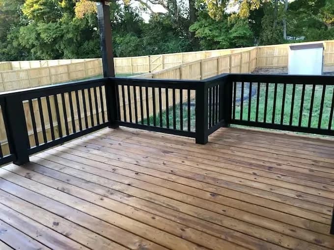 Painting project by Fresh Coat Painters of Clarksville in Clarksville, Tennessee. The image shows a finished wood deck with railing.
