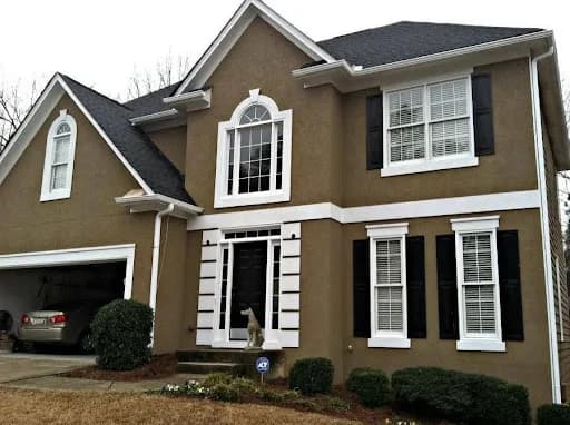 Painting work by Nashville Painting Company - Brentwood in Brentwood, Tennessee. The image shows a brown two-story home with white trim and dark shutters.